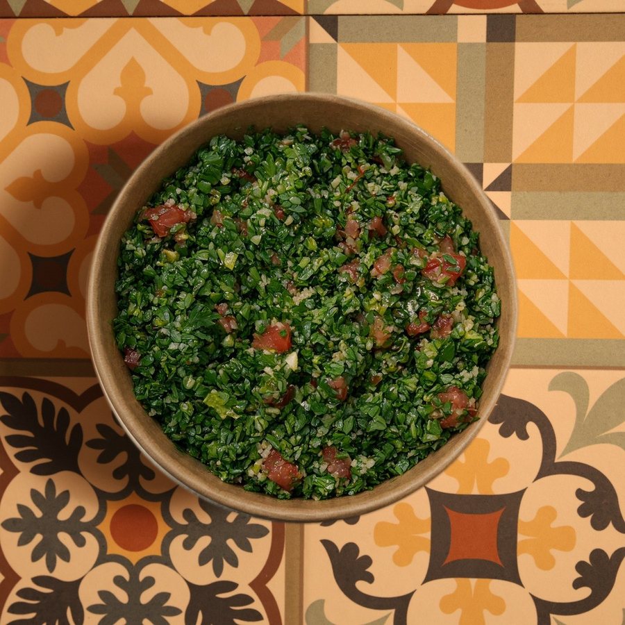 Fresh tabbouleh in a kraft bowl, seen from above